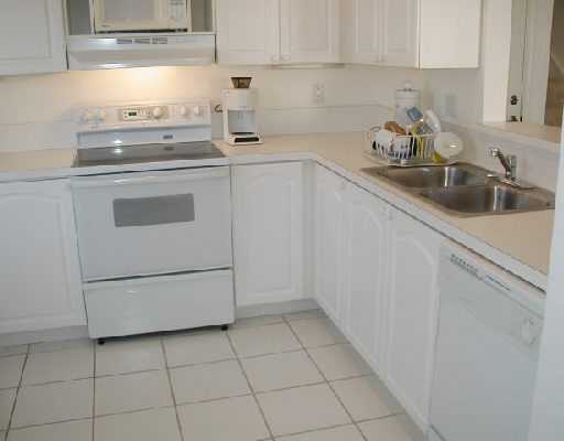 1154 Via Jardin, Unit 1154 Riviera Beach, FL 33418 - Photo 6 of 16 a kitchen with a sink a stove and cabinets
