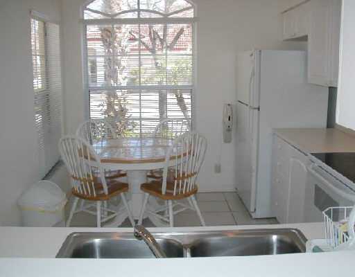 1154 Via Jardin, Unit 1154 Riviera Beach, FL 33418 - Photo 8 of 16 a view of dining room and kitchen with a floor to ceiling window