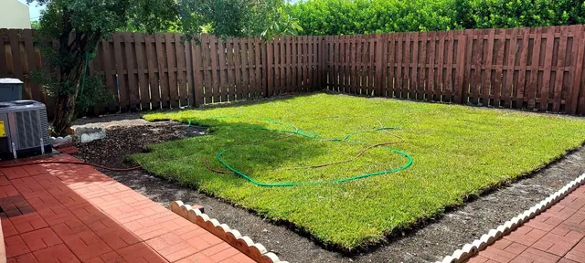 a view of a backyard with wooden fence