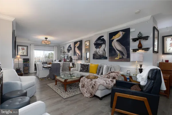 a living room with furniture and painting on the wall