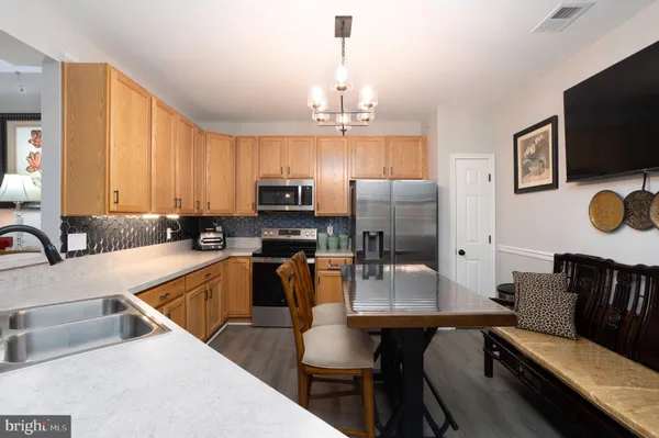a kitchen with kitchen island granite countertop a sink dining table and chairs