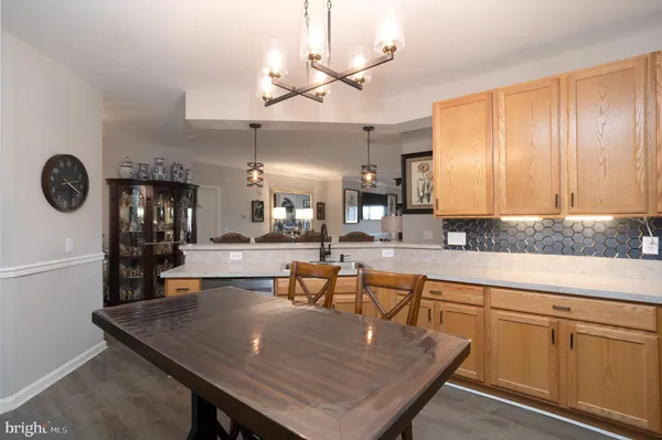 a kitchen with a table chairs and cabinets