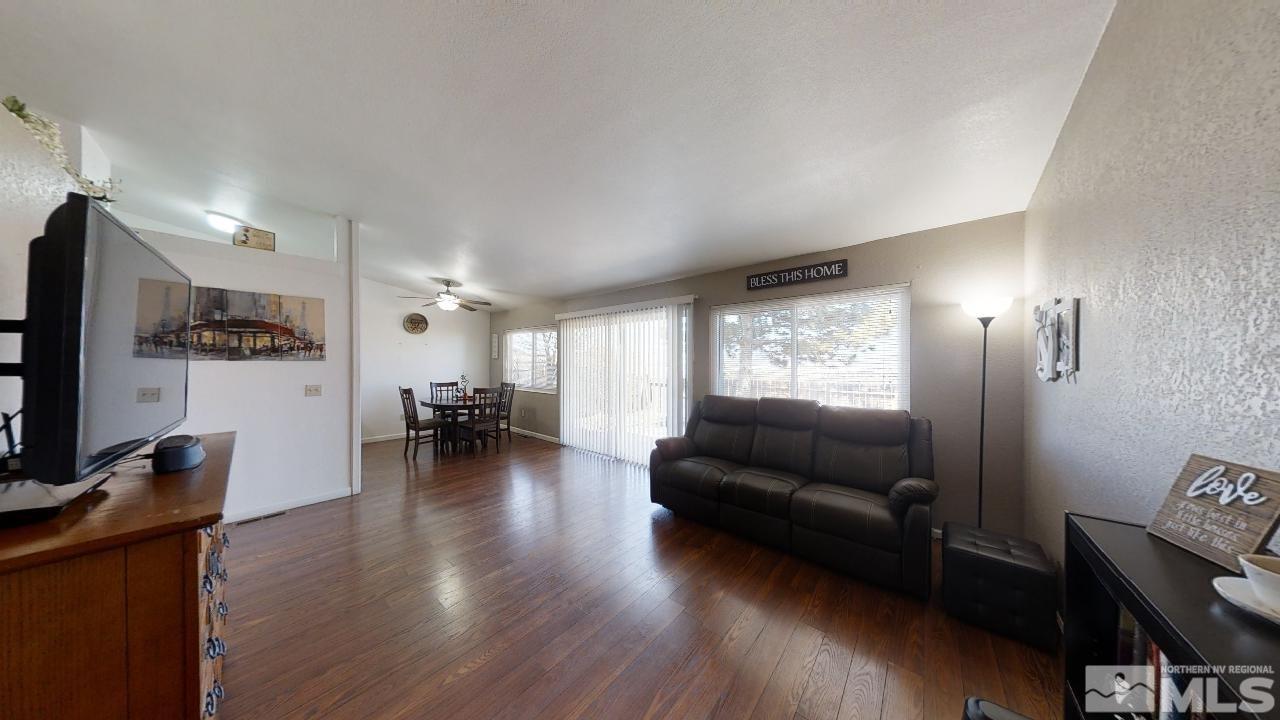 7015 Indigo Circle Reno, NV 89506 - Photo 3 of 12 a living room with furniture and a flat screen tv