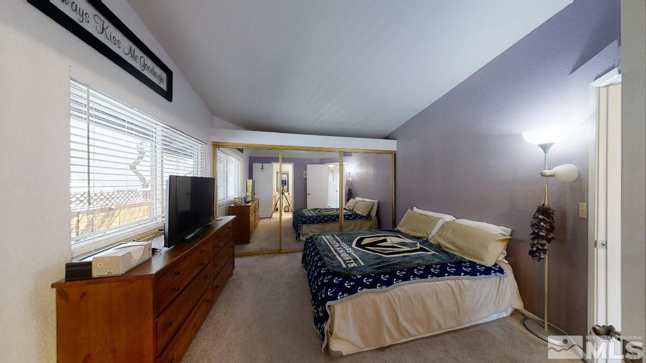 7015 Indigo Circle Reno, NV 89506 - Photo 9 of 12 a bedroom with furniture and a flat screen tv