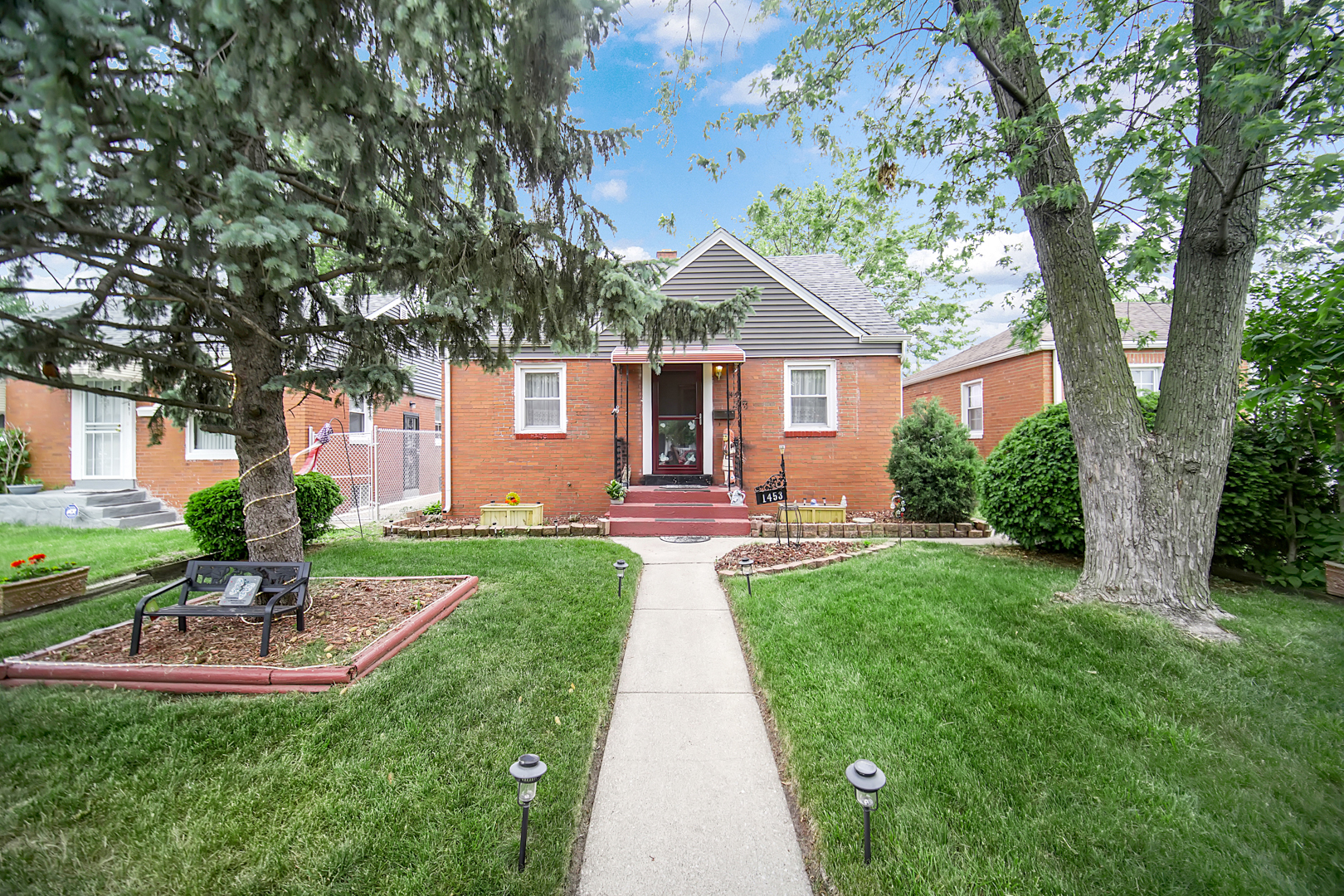 a front view of a house with a yard and porch