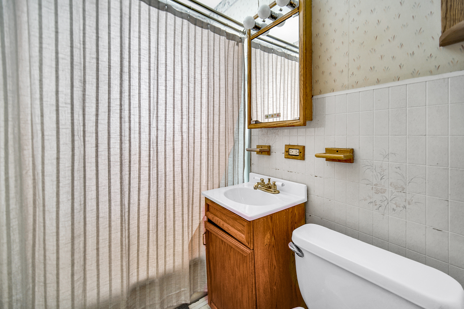 1453 Shell Street Hammond, IN 46320 - Photo 6 of 23 a bathroom with a sink a toilet and a mirror