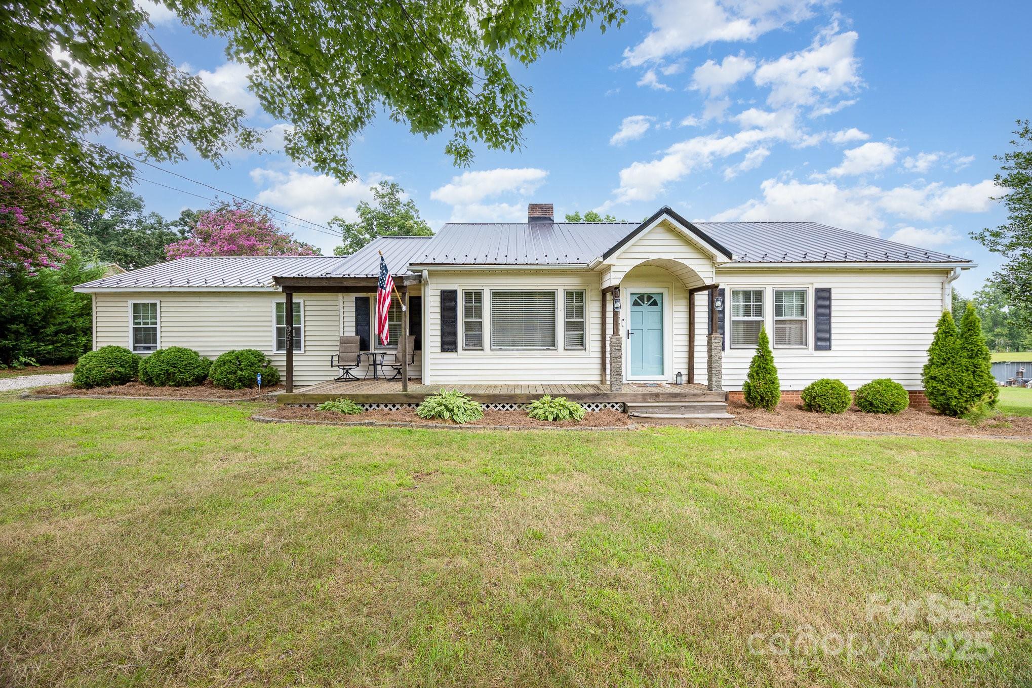 a front view of house with yard and green space