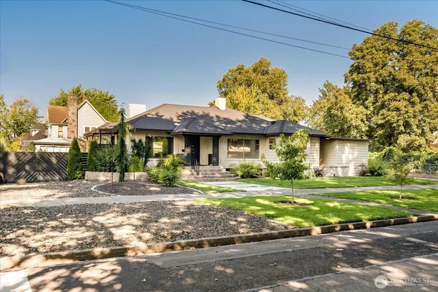 a front view of a house with a garden and porch