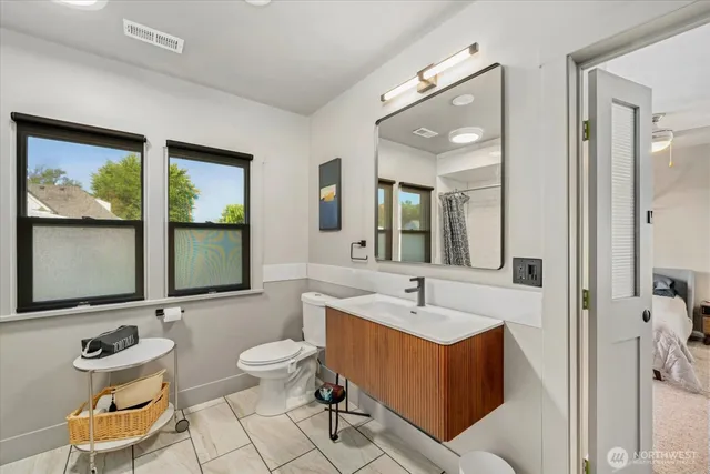a bathroom with a toilet sink and mirror
