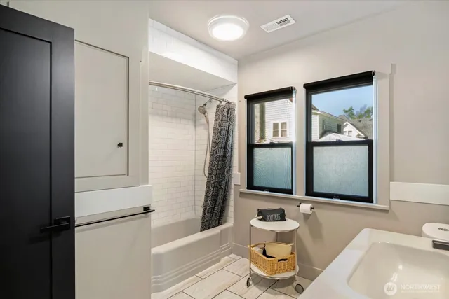 a bathroom with a sink mirror toilet and bathtub