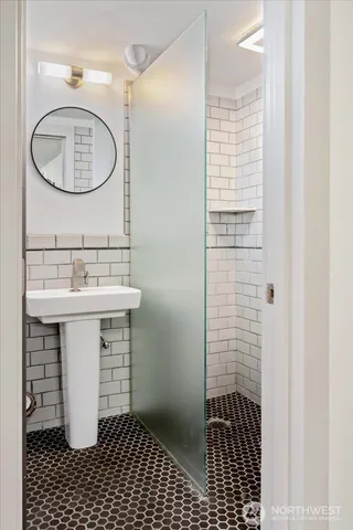 a bathroom with a sink a toilet and a mirror