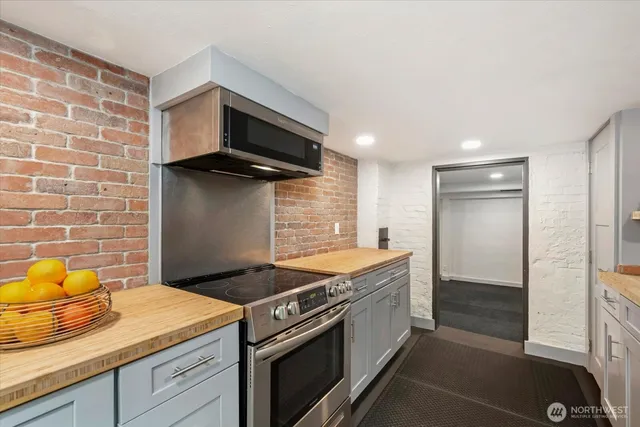 a kitchen with stainless steel appliances granite countertop a sink and a stove
