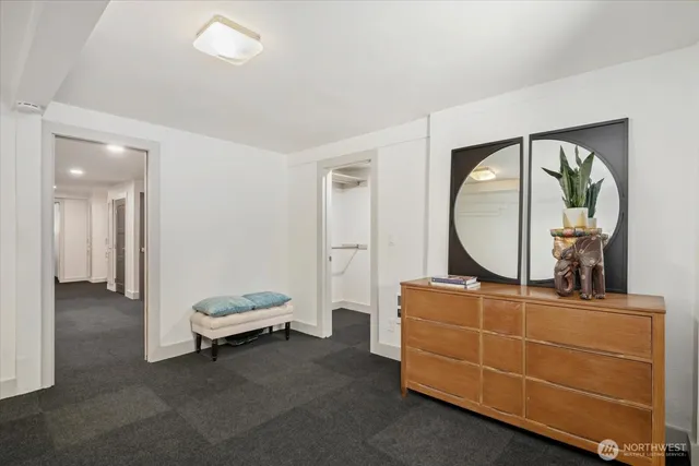 a living room with furniture and a mirror