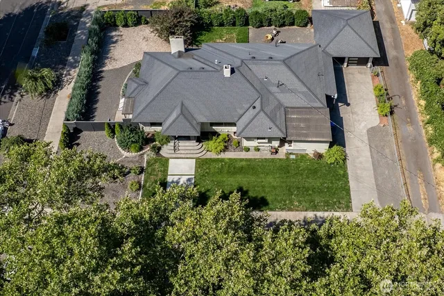 an aerial view of a house with a yard