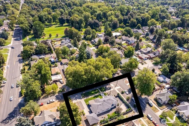 an aerial view of a house with a yard and garden