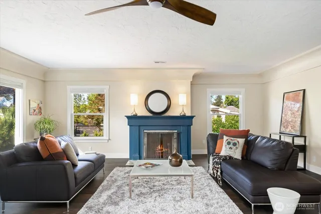 a living room with furniture a window and a fireplace