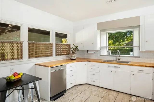 a kitchen with stainless steel appliances granite countertop a sink and a window