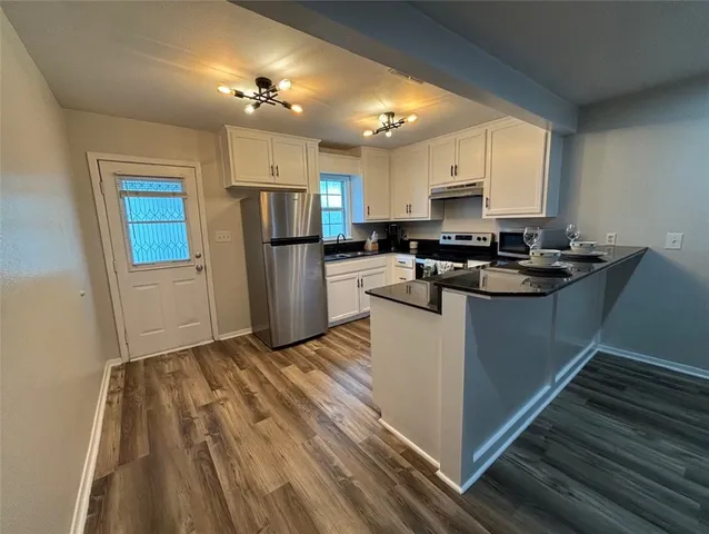 a kitchen with a sink appliances and cabinets