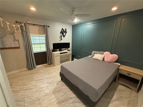 a bedroom with a bed and a flat screen tv