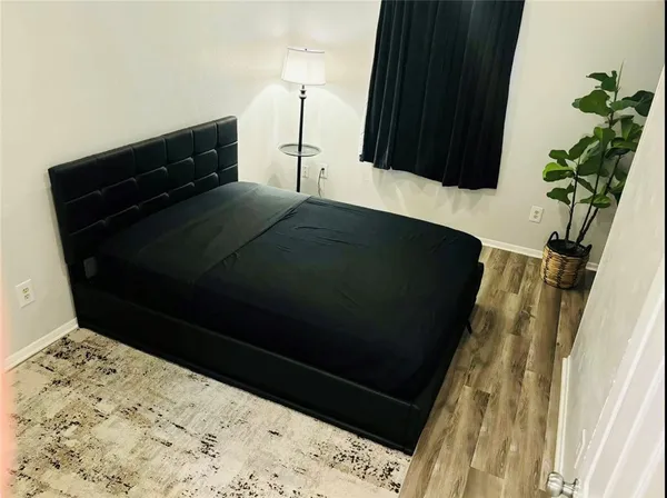 a bedroom with a bed and a table