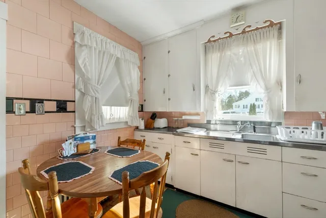 a kitchen with a sink stove and cabinets