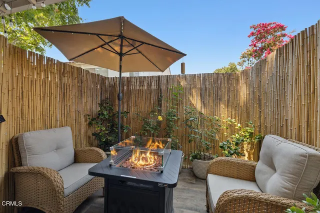 a outdoor living space with furniture and umbrella