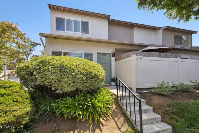 a view of a house with wooden fence