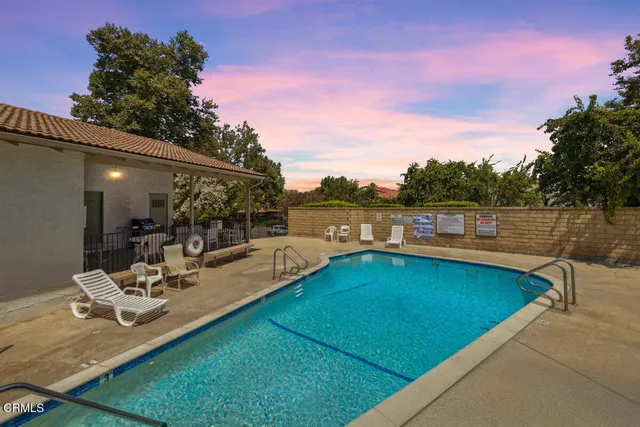 a view of a swimming pool with lounge chairs