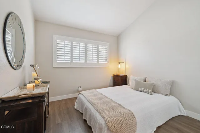 a bedroom with a bed a window and a chandelier