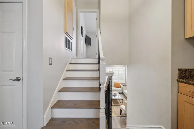 a view of staircase with white walls and windows