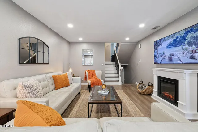 a living room with furniture and a fireplace
