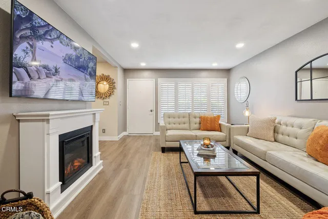 a living room with furniture and a fireplace