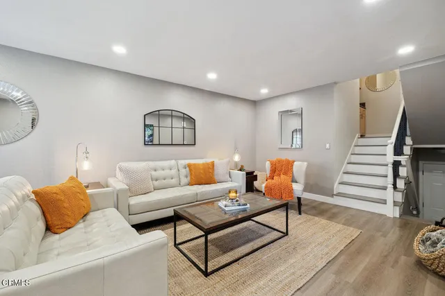 a living room with furniture and wooden floor