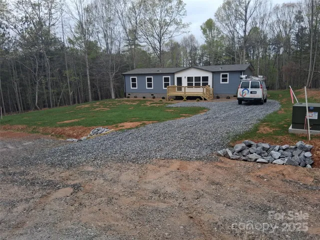 a view of a house with a yard and sitting area