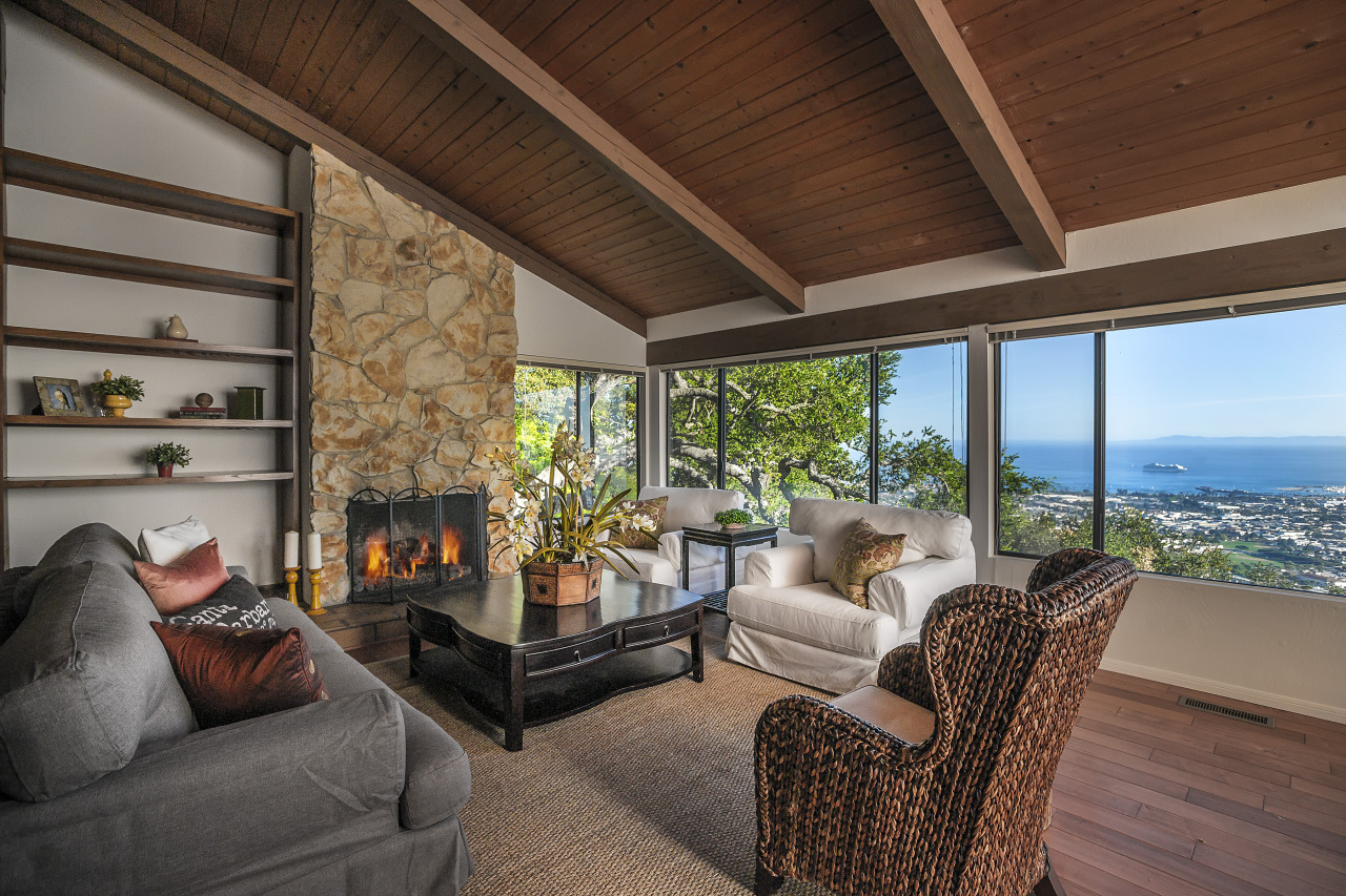 1500 Franceschi Road Santa Barbara, CA 93103 - Photo 1 of 18 a living room with furniture a fireplace and a floor to ceiling window