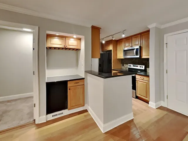 a kitchen with stainless steel appliances a refrigerator stove and microwave