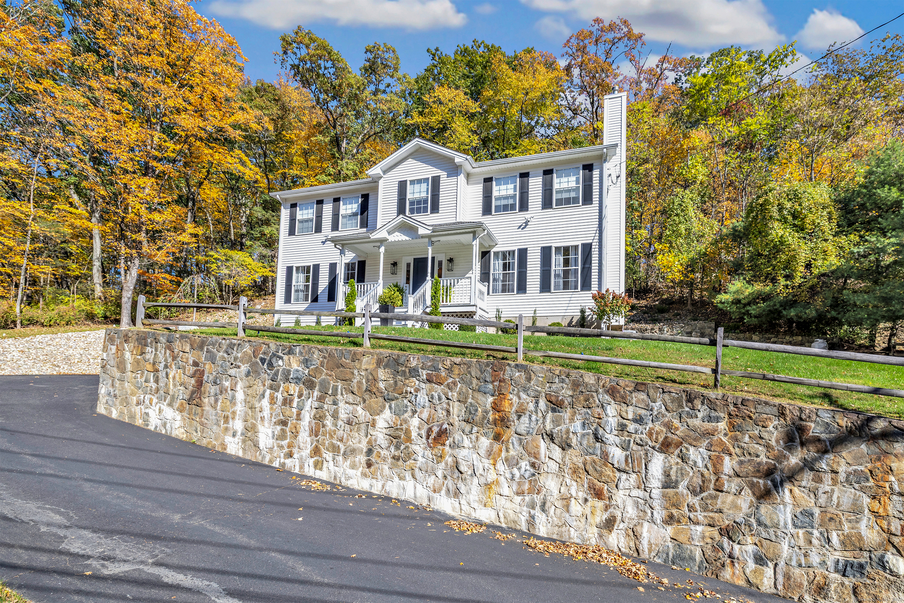 a front view of a house with a yard and potted plants