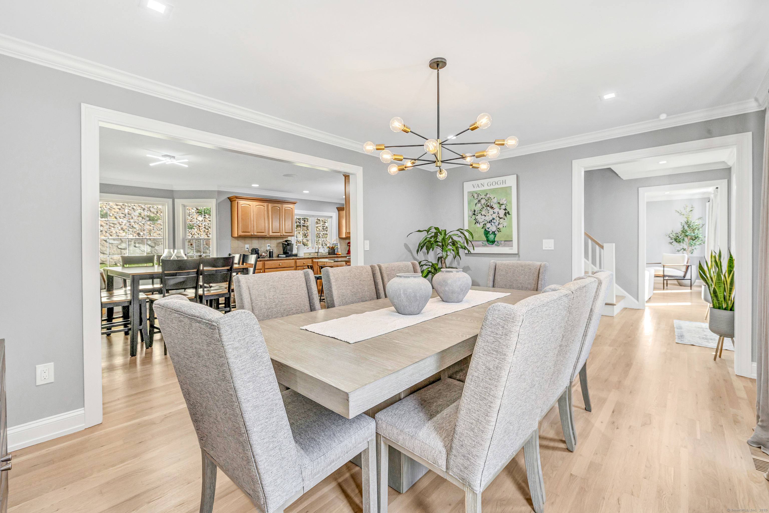6680 Main Street Trumbull, CT 06611 - Photo 11 of 40 a view of a dining room and livingroom with furniture wooden floor a chandelier