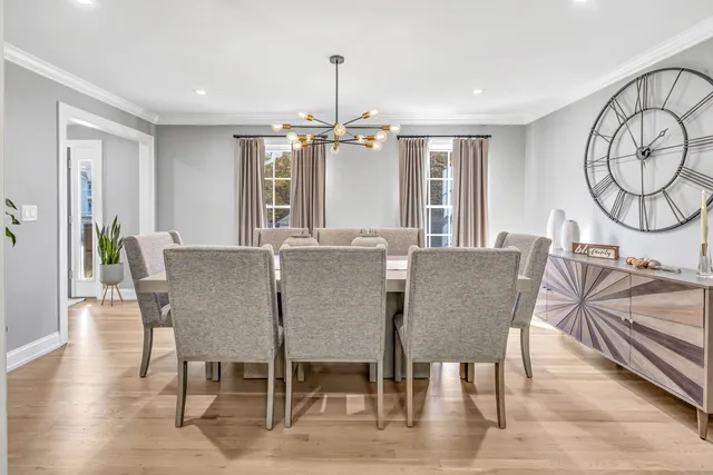 a view of a a dining room with furniture window and wooden floor