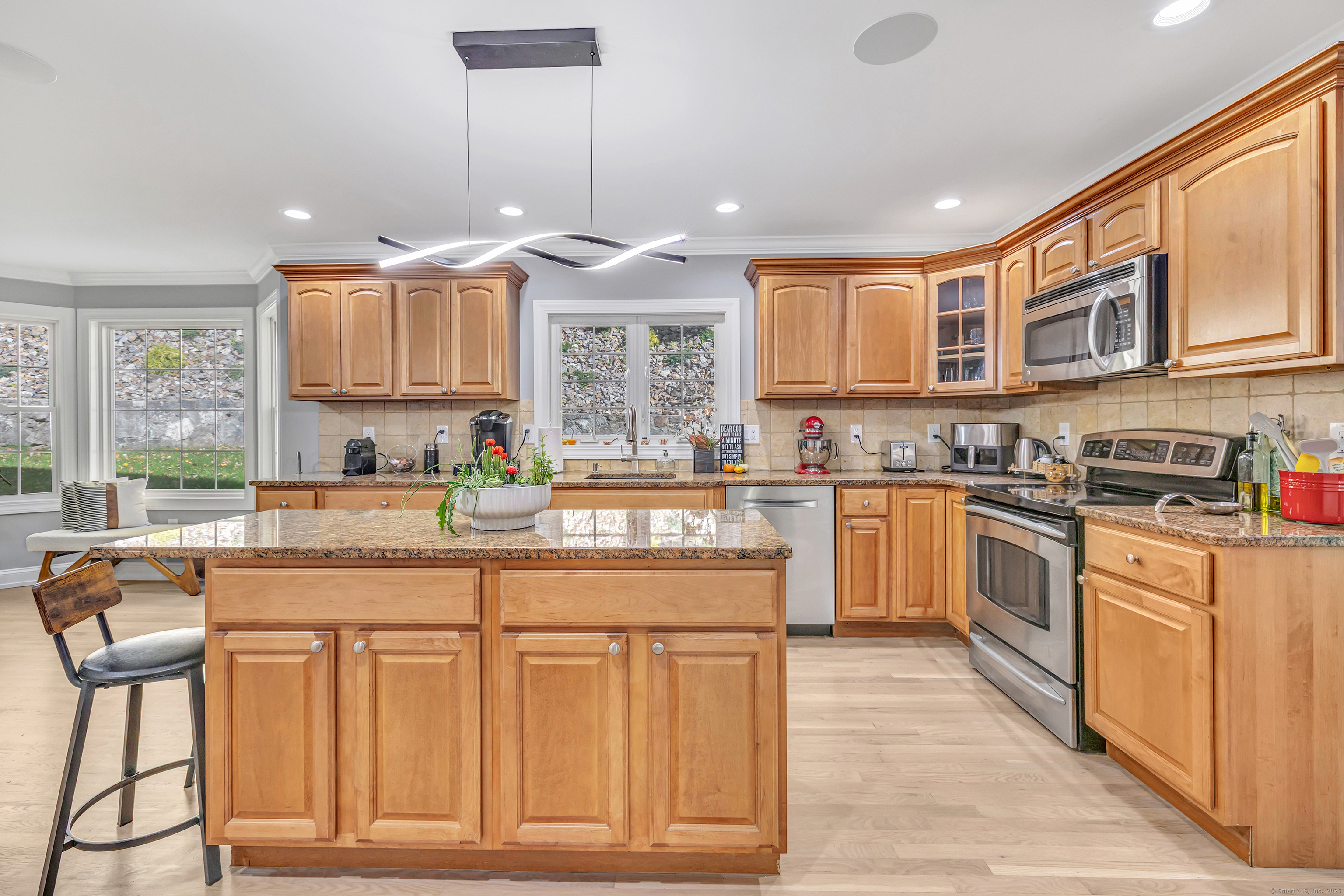 6680 Main Street Trumbull, CT 06611 - Photo 14 of 40 a kitchen with stainless steel appliances granite countertop a stove and cabinets