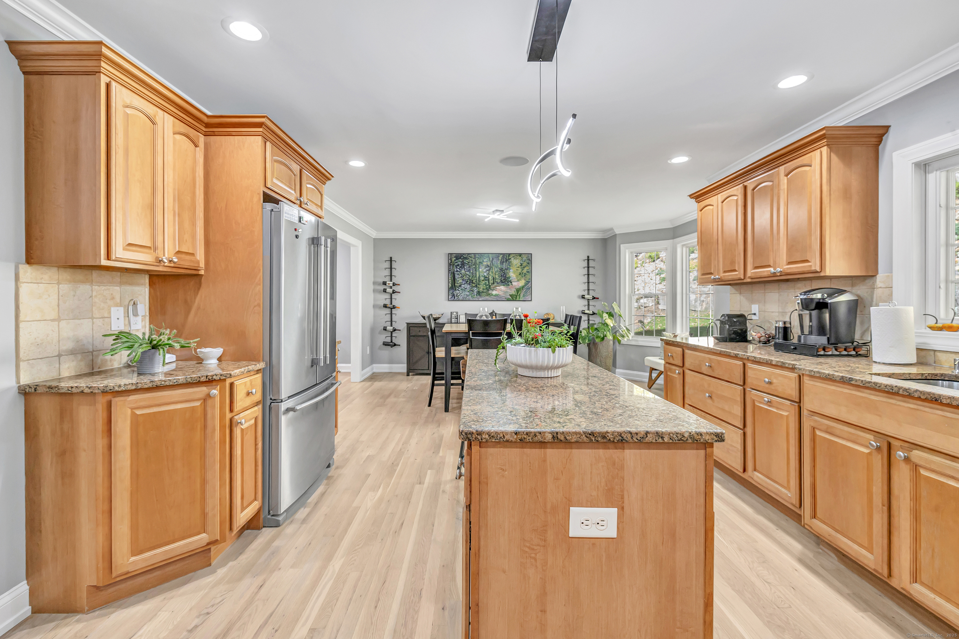 6680 Main Street Trumbull, CT 06611 - Photo 15 of 40 a kitchen with stainless steel appliances granite countertop a refrigerator a sink dishwasher a oven with white cabinets and wooden floor