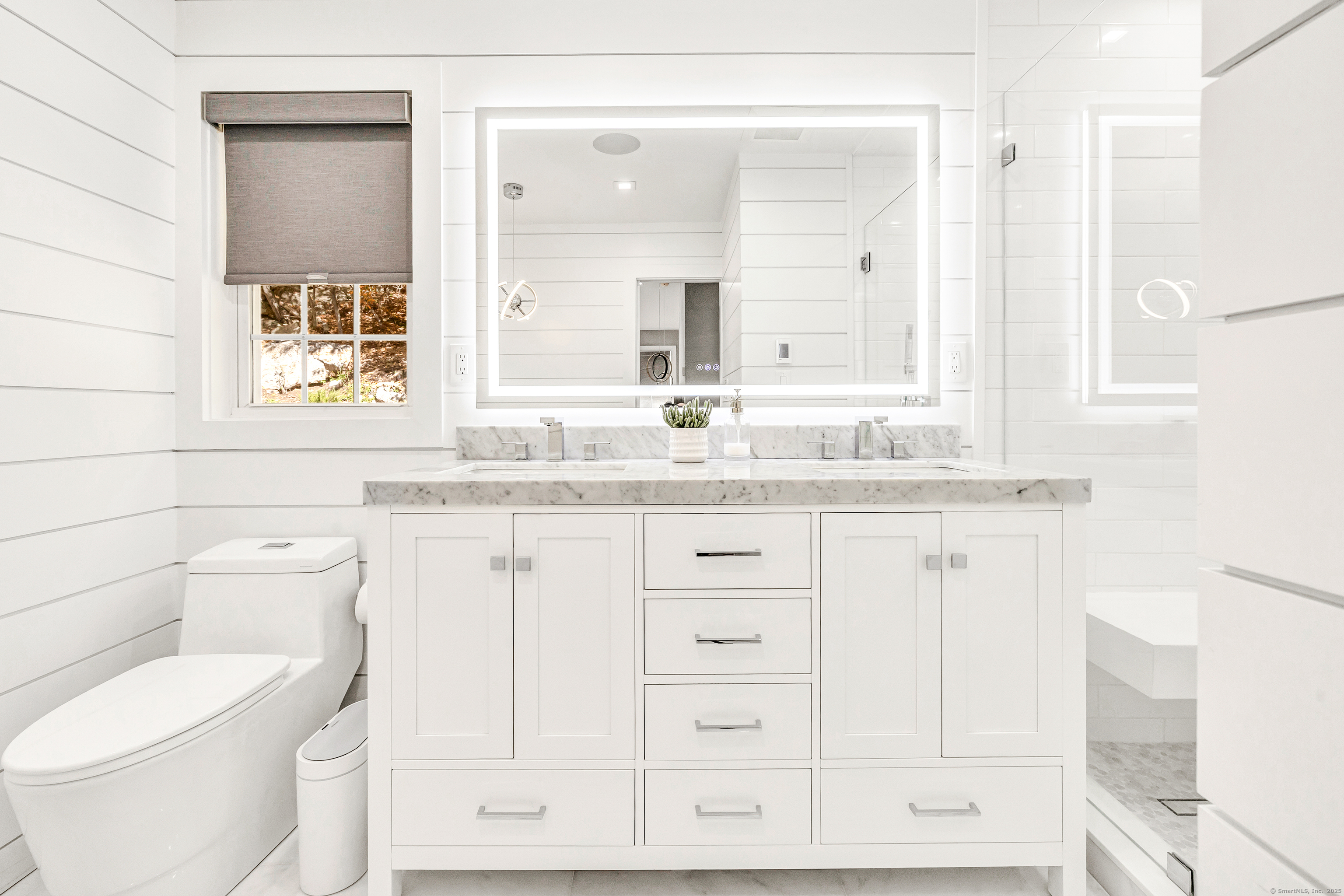 6680 Main Street Trumbull, CT 06611 - Photo 21 of 40 a bathroom with a granite countertop toilet sink and mirror
