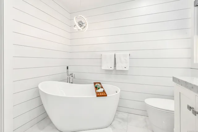 a white bath tub sitting in a bathroom