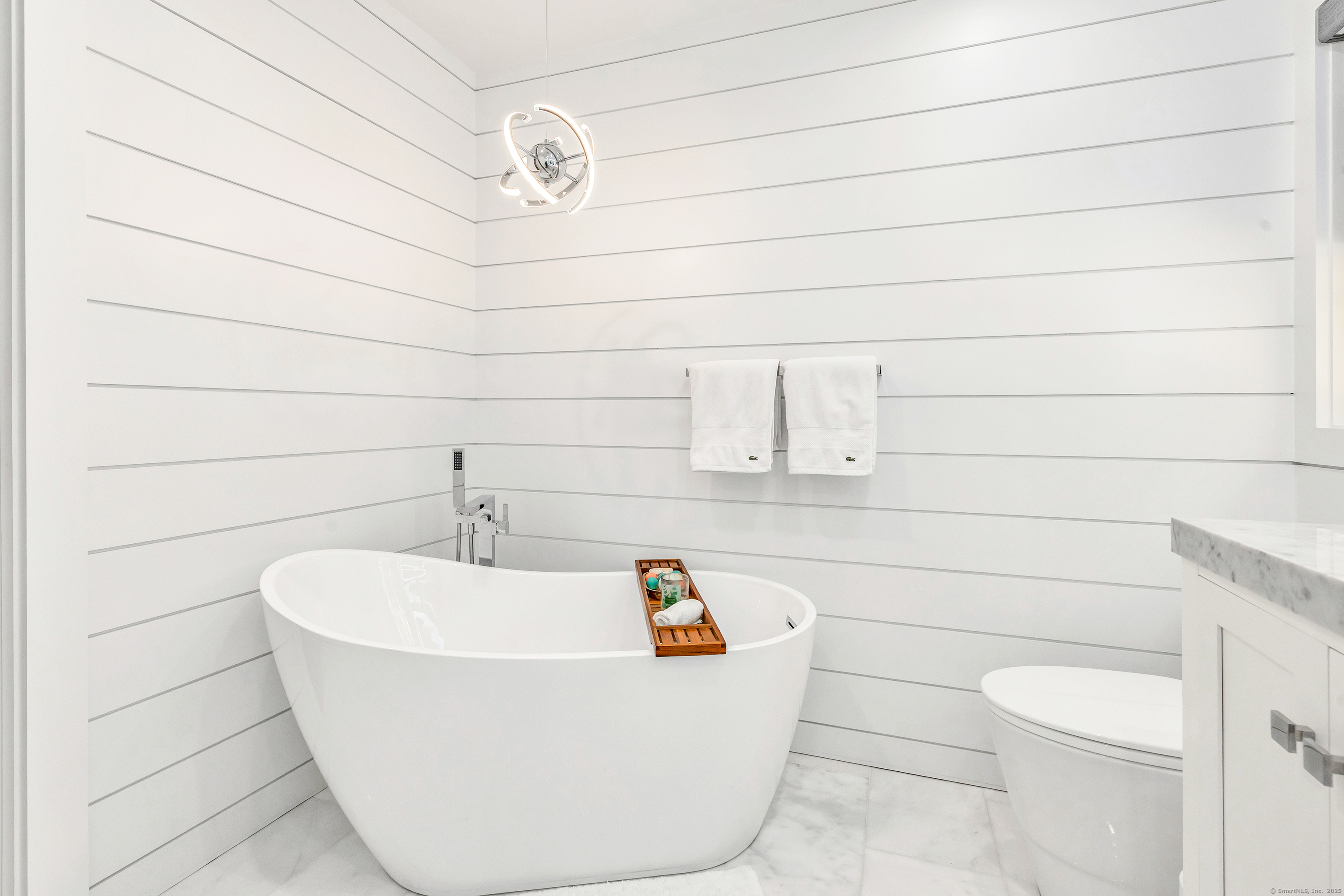 6680 Main Street Trumbull, CT 06611 - Photo 23 of 40 a white bath tub sitting in a bathroom