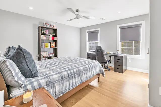 a bed sitting in a bedroom next to a window