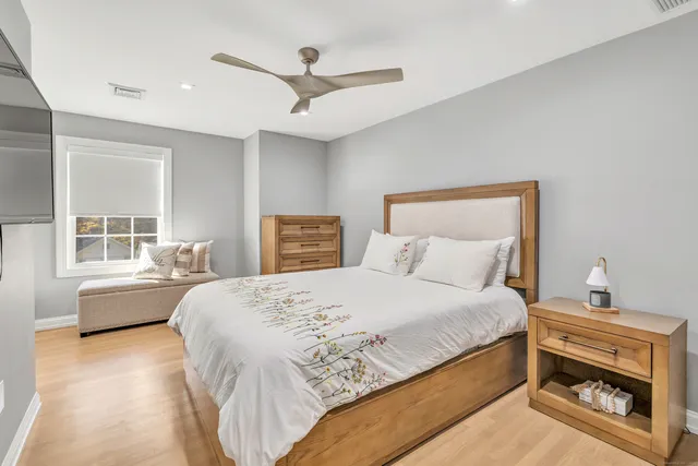 a spacious bedroom with a large bed and a couch