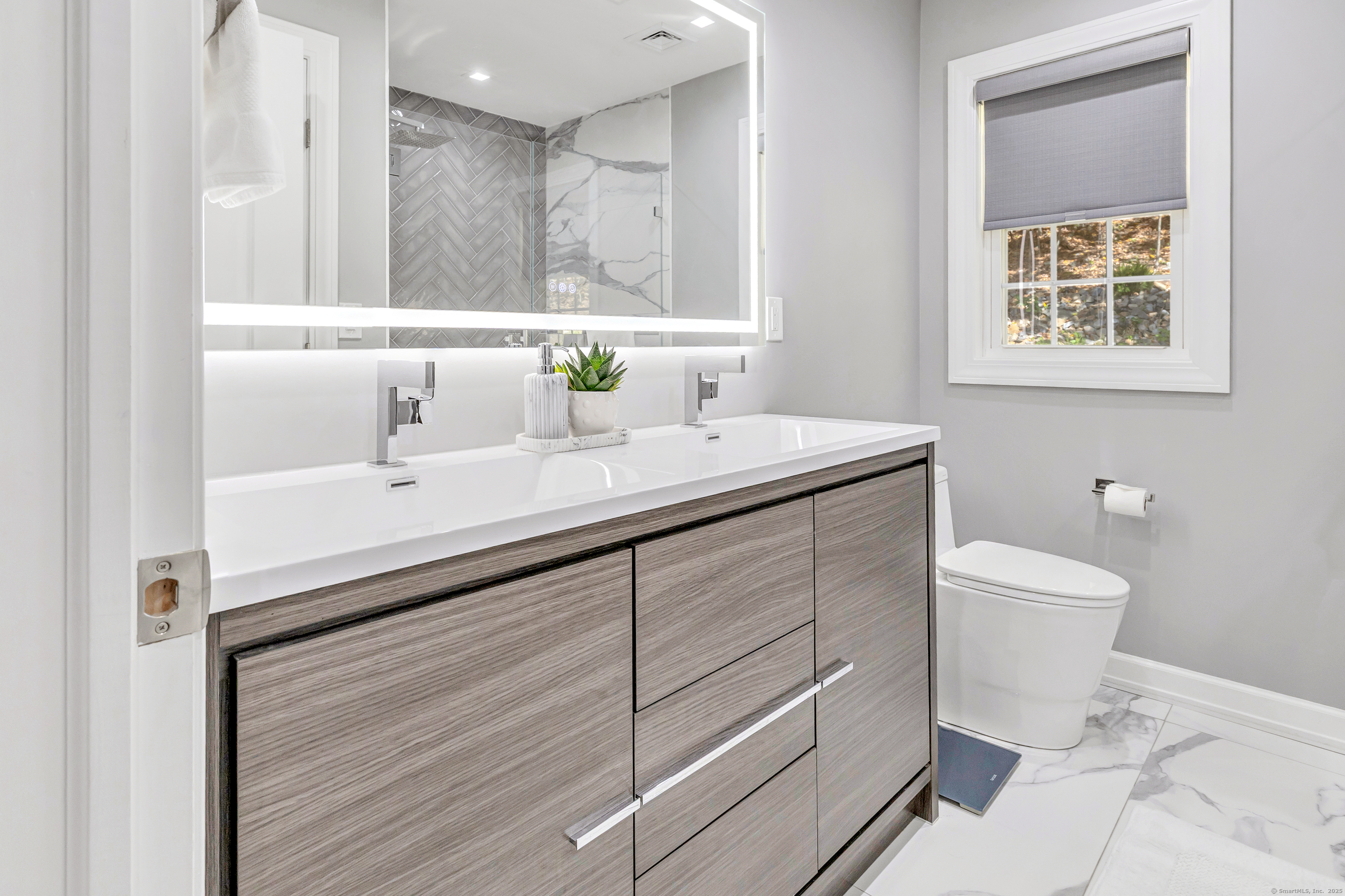 6680 Main Street Trumbull, CT 06611 - Photo 30 of 40 a bathroom with a sink and a mirror