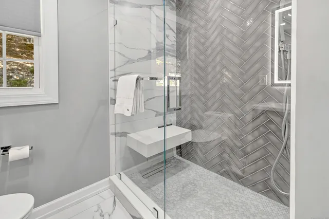 a bathroom with a toilet and a shower