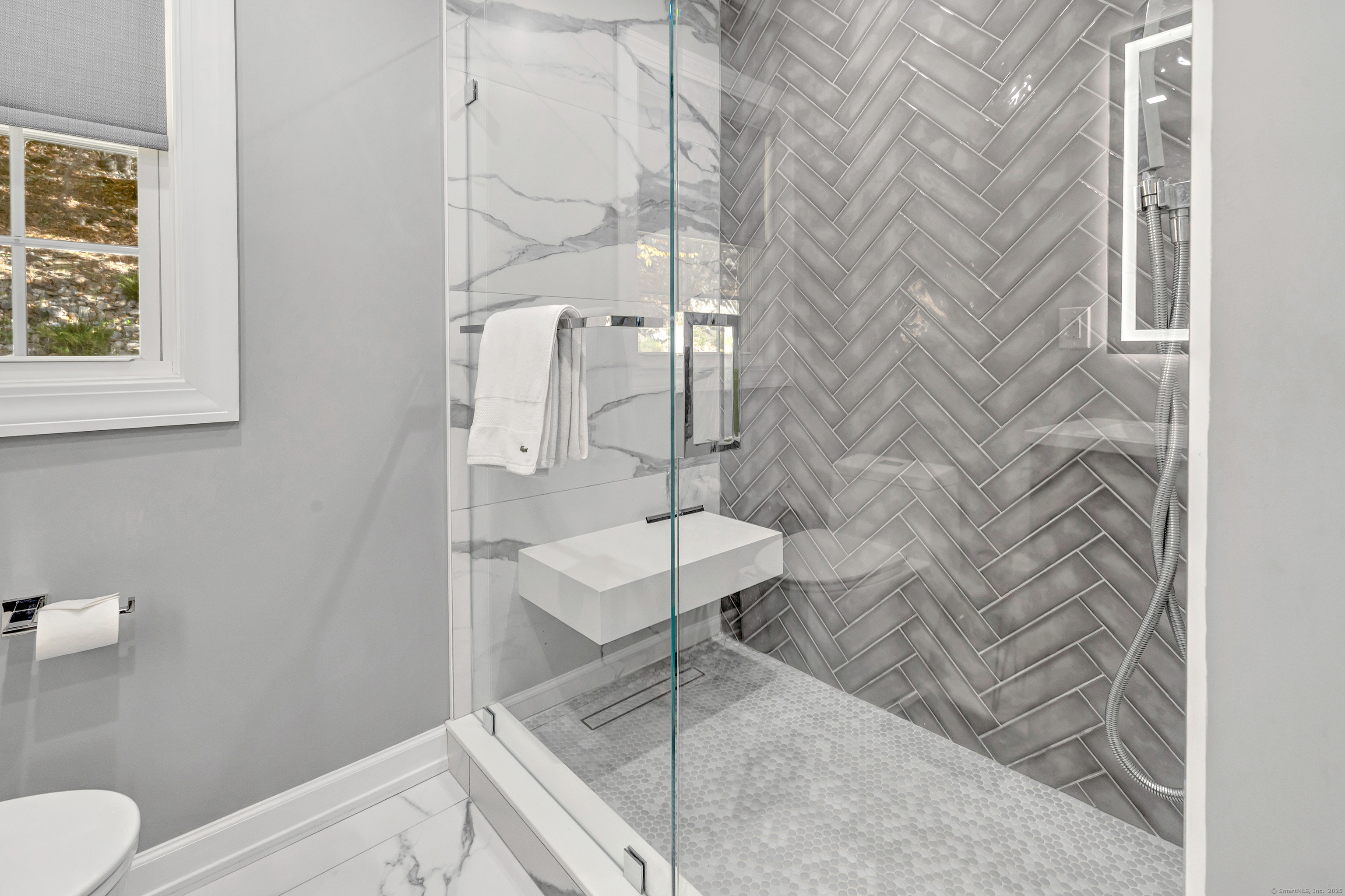 6680 Main Street Trumbull, CT 06611 - Photo 31 of 40 a bathroom with a toilet and a shower