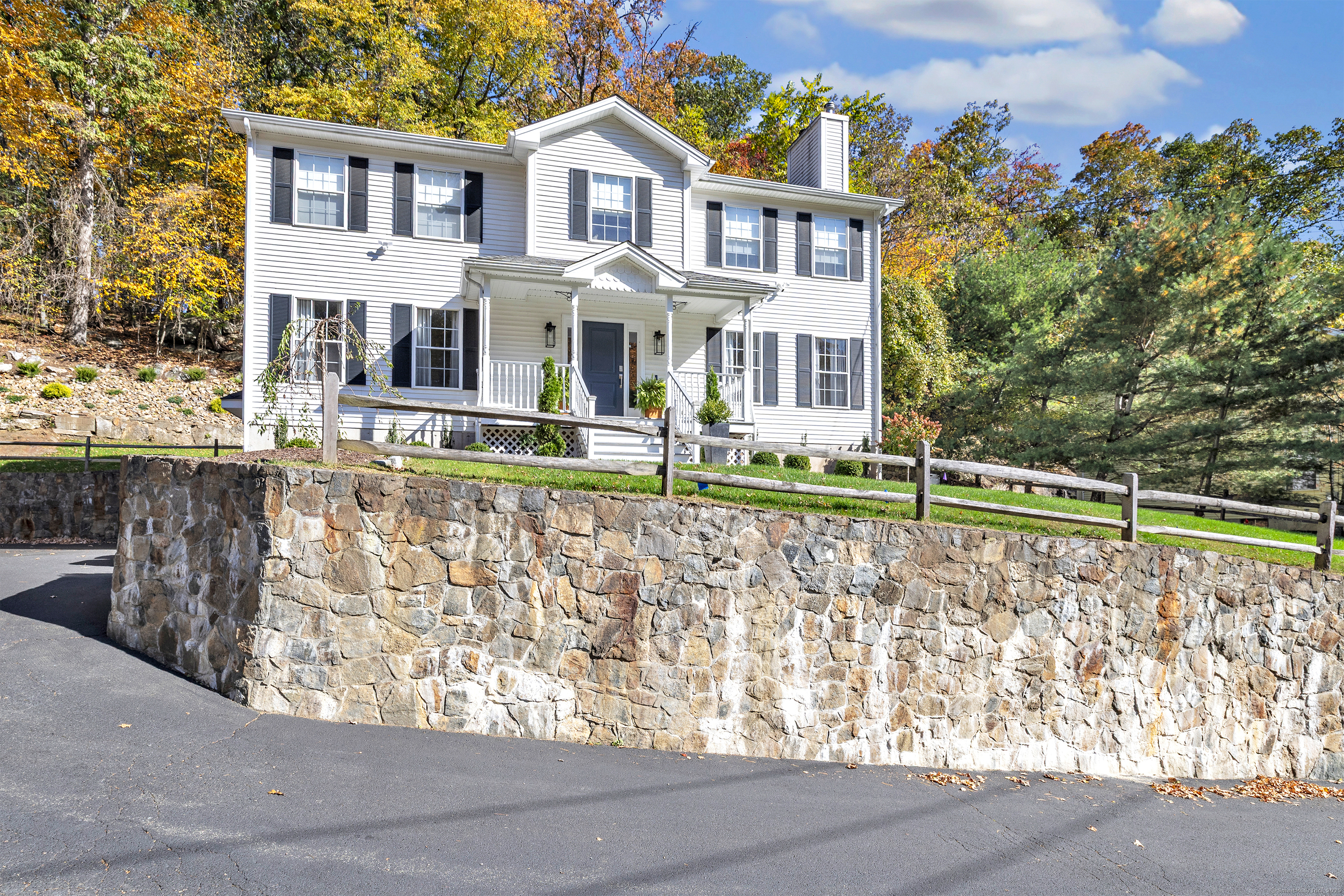 6680 Main Street Trumbull, CT 06611 - Photo 38 of 40 a front view of a house with a yard and fountain
